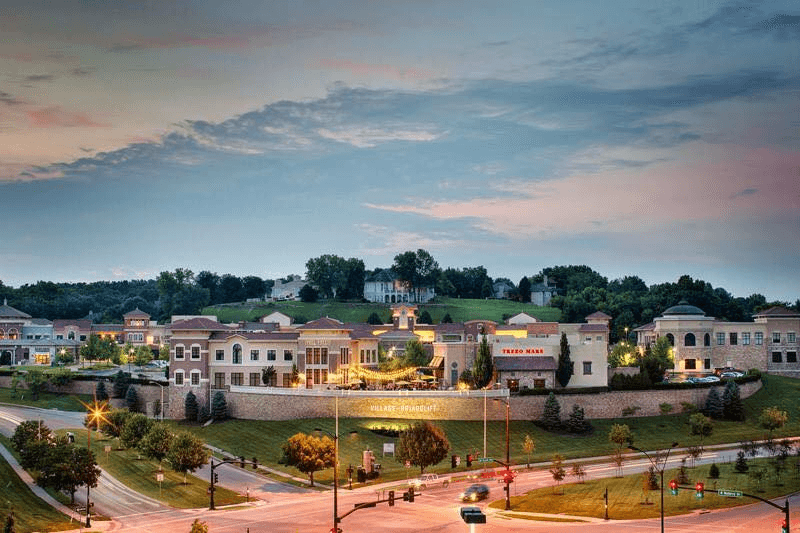 Briarcliff Village storefronts and homes at dusk