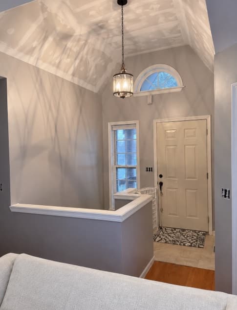 Tall entry with freshly finished drywall on the ceiling