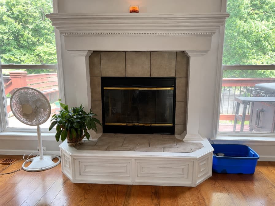 Finished white fireplace surround with a tiled hearth